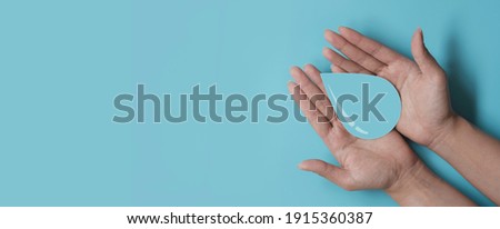 woman hands holding water drop, world water day, CSR, save water resource, world ocean day concept Royalty-Free Stock Photo #1915360387