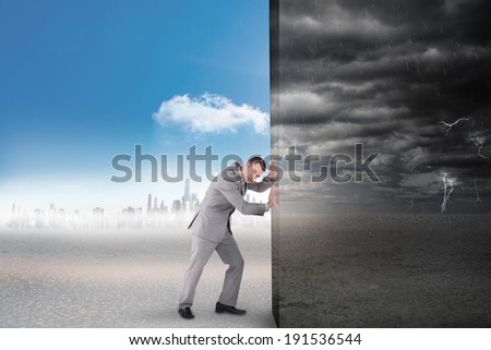 Composite image of businessman pushing away scene of ominous landscape