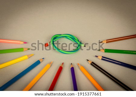 Multicolor pencils and flexible pencil on a light background. Close up. Selective focus