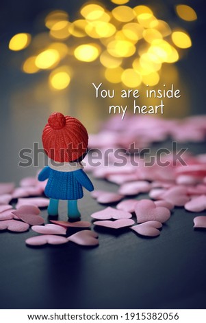doll and hearts on abstract bokeh dark background. You are inside my heart - inspiration quote of love. Valentine's Day, 14 february, romantic date concept