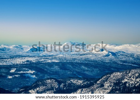 Snowy mountains in the Norwegian wilderness on a cold clear winter evening.