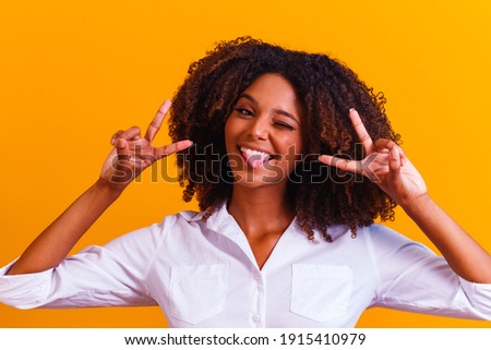 afro woman making V sign with hands. Happy afro girl with good vibe making peace and love with hands