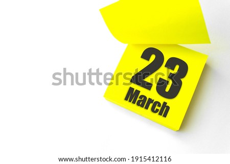 March 23rd. Day 23 of month, Calendar date. Close-Up Blank Yellow paper reminder sticky note on White Background. Spring month, day of the year concept Royalty-Free Stock Photo #1915412116