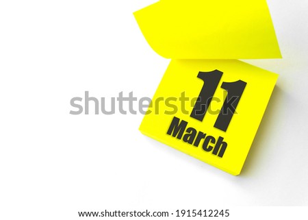 March 11st . Day 11 of month, Calendar date. Close-Up Blank Yellow paper reminder sticky note on White Background. Spring month, day of the year concept