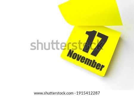 November 17th. Day 17 of month, Calendar date. Close-Up Blank Yellow paper reminder sticky note on White Background. Autumn month, day of the year concept