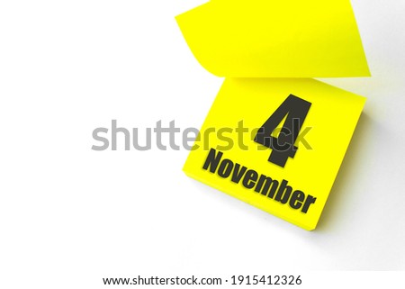 November 4th. Day 4 of month, Calendar date. Close-Up Blank Yellow paper reminder sticky note on White Background. Autumn month, day of the year concept