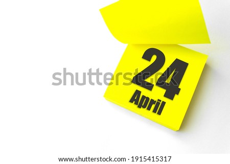 April 24th. Day 24 of month, Calendar date. Close-Up Blank Yellow paper reminder sticky note on White Background. Spring month, day of the year concept
