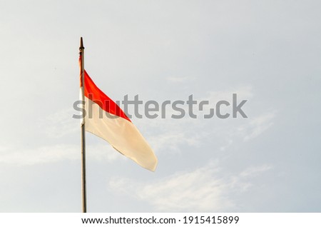 "Merah Putih", Indonesian national flag flying against a clear sky background