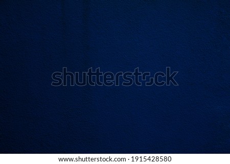 texture of a dark blue wall covered with volumetric plaster, space for text, space for copy