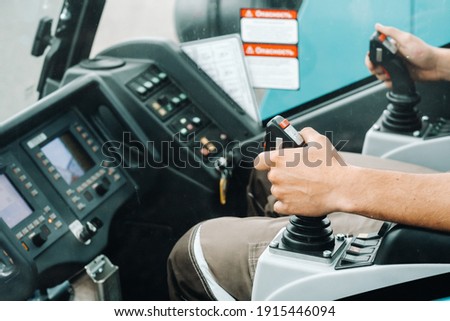 Close up of a hand holding the control stick and ready to work in the truck crane the largest truck crane for challenging tasks. Royalty-Free Stock Photo #1915446094
