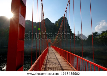 Orange Bridge cross over Nam Song River, which leading to Jang Cave in Vang Vieng, Laos
