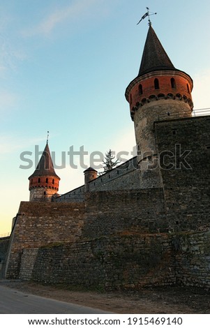 Beautiful landscape photo of ancient Kamianets-Podilskyi Castle. High and thick stone walls with towers against blue sky.Abstract photo of stone walls. Major tourist attraction in Kamianets-Podilskyi.