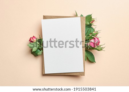 Greeting card with fresh roses flowers on paper background Royalty-Free Stock Photo #1915503841