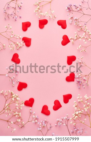 Red hearts and flowers background, romantic concept, top view. Valentines Day greeting card concept. Mothers Day anniversary design.