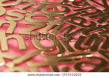 gold colored alphabets on the red background              
