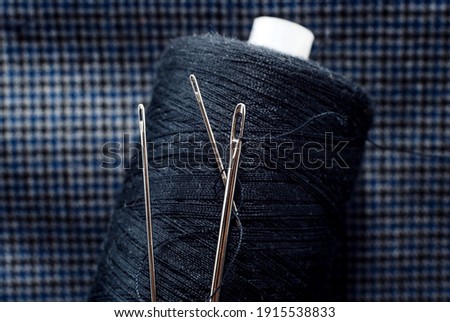 Needle and thread close-up. Macro. Items for the work of a tailor and seamstress. Crafts