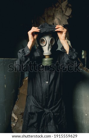 Apocalypse warrior in gas mask listens to silence