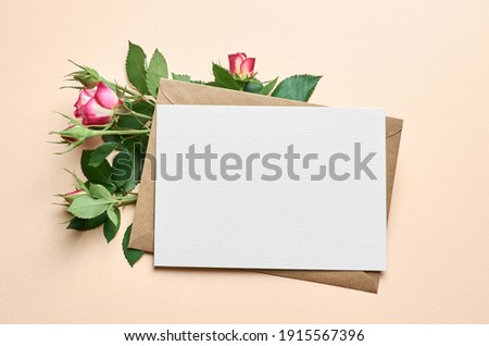 Greeting card with fresh roses flowers frame on paper background, card mockup with copy space Royalty-Free Stock Photo #1915567396
