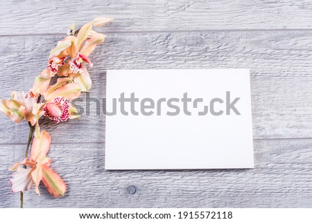 business card mockup with a flowers on a table.