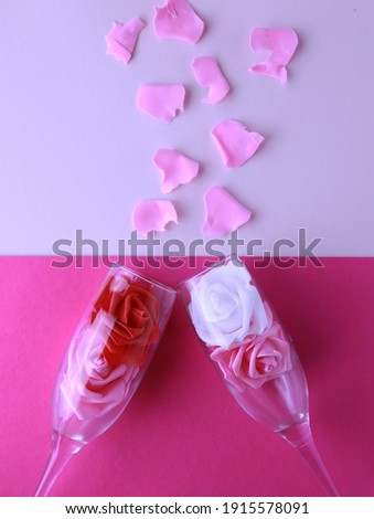 Champagne glass filled with flowers, petals around, Valentine's Day
