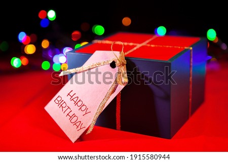 Gift box with a label, red background.