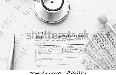 Health Insurance Claim Form. Individual medical health insurance policy with stethoscope and dollar banknotes.