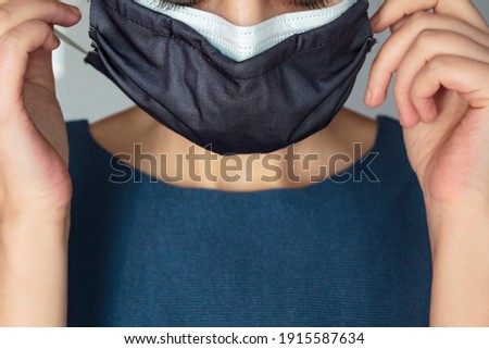 Woman wearing two protective face masks at the same time