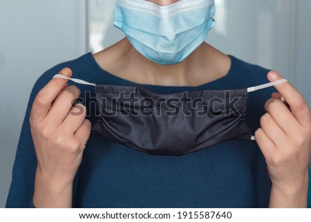 Woman putting a second face mask