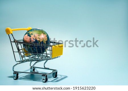 planet earth in supermarket trolley, online shopping. Concepth photo of Earth Day