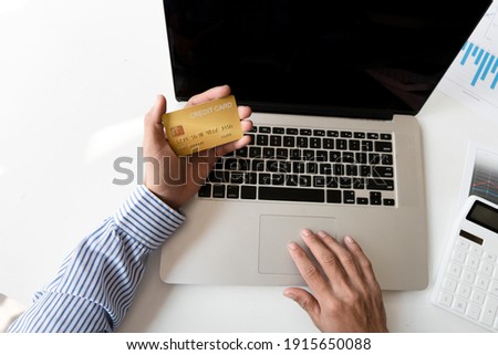 Top view,business hands holding credit card and using laptop computer for online shopping, Online payment and shopping
