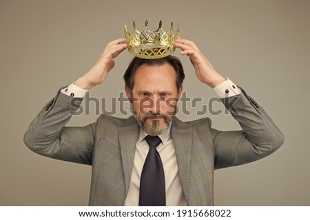 Kill your pride before you lose your head. Big boss wear crown with pride. Proud businessman grey background. Bearded man in formalwear. Pride and egoism. Pride and ambitions. Toxic ego. Royalty-Free Stock Photo #1915668022