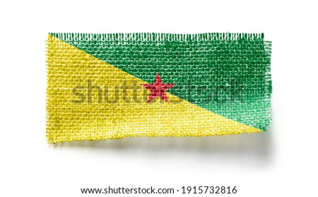 French Guiana flag on a piece of cloth on a white background