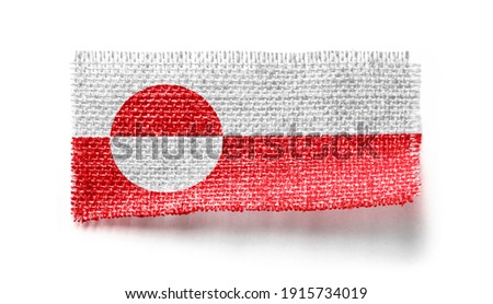 Greenland flag on a piece of cloth on a white background