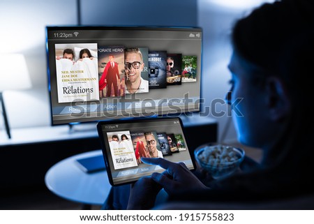 Woman Watching TV Through Tablet Television And Movie Streaming