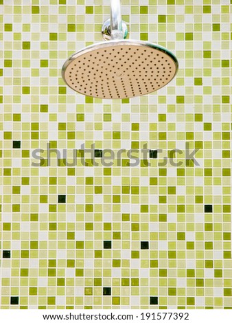 shower on green tile wall