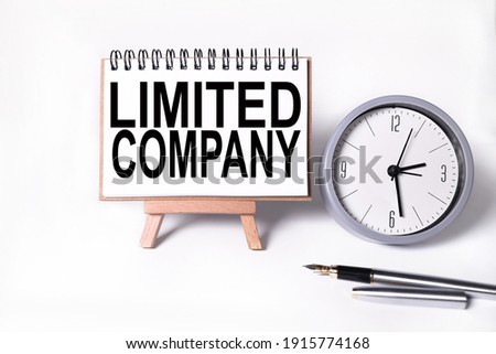 limited company. text on white notepad paper on white background. near the table clock Royalty-Free Stock Photo #1915774168