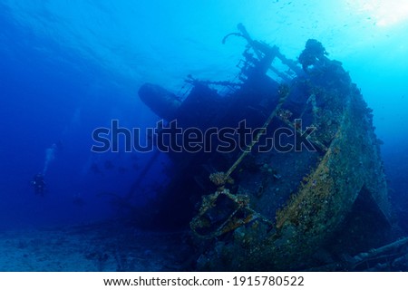 scuba divers enjoying famous giannis d ship wreck in clear water  Royalty-Free Stock Photo #1915780522