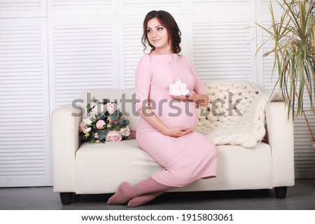 Beautiful pregnant girl with a big belly. Young married pregnant couple. Husband with pregnant wife. A couple awaiting the birth of a baby.