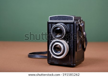Vintage camera on green background