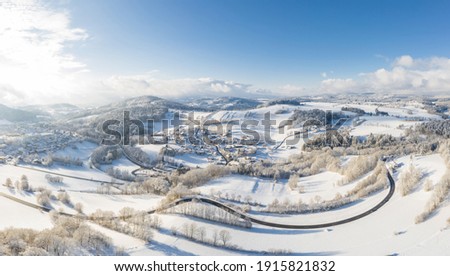 Picture of an aerial view with a drone of the village Grueb near Grafenau in the Bavarian forest with mountains and landscape in winter with snow and ice, Germany