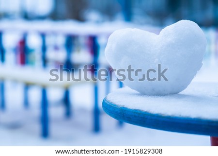 Snowy heart close up in winter. Love symbol for valentine's day and eighth march