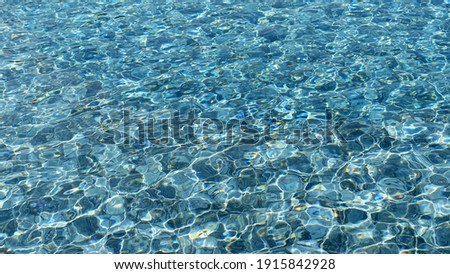 Background picture. Swimming pool bottom ripple and with waves background. Summer background. Texture of water surface.
