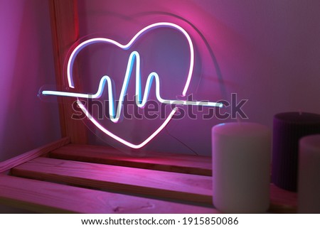Neon sign pink and blue heart in the decor of the home. Trendy style. Neon sign. Custom neon. Home decor. Valentine day. Modern trendy background.