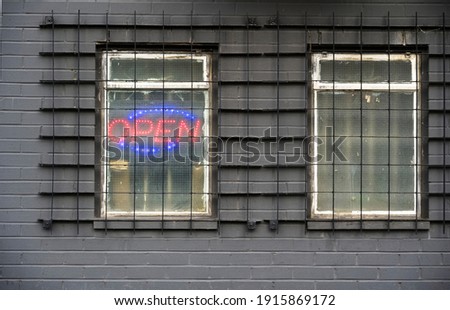 Illuminated red open sign on shop window