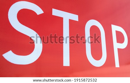 Stop traffic sign, white letters on white background. Deatail.