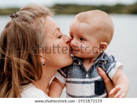 mother holding and kissing son