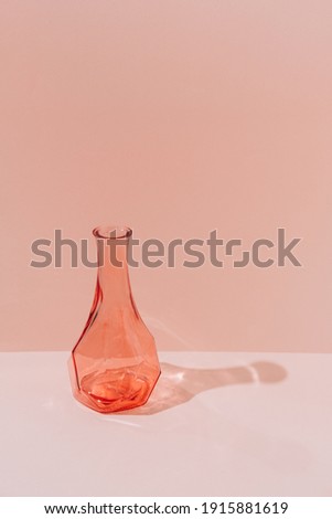Transparent vase in geometry style with shadow on beige background. Minimalism.