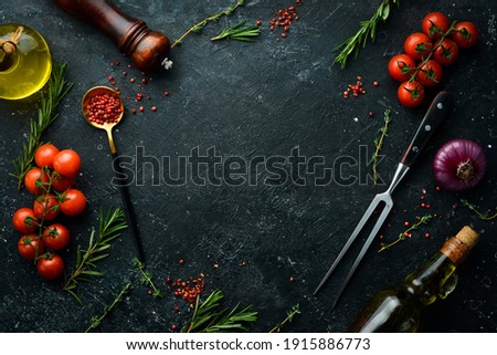Black stone cooking background. Spices and vegetables. Top view. Free space for your text. Royalty-Free Stock Photo #1915886773
