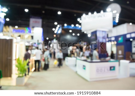 Abstract blur people in exhibition hall event trade show expo background. Large international exhibition, convention center, business marketing and event fair organizer concept. Royalty-Free Stock Photo #1915910884