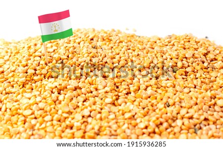Tajikistan flag sticking in a bunch of peas. The concept of export and import of peas